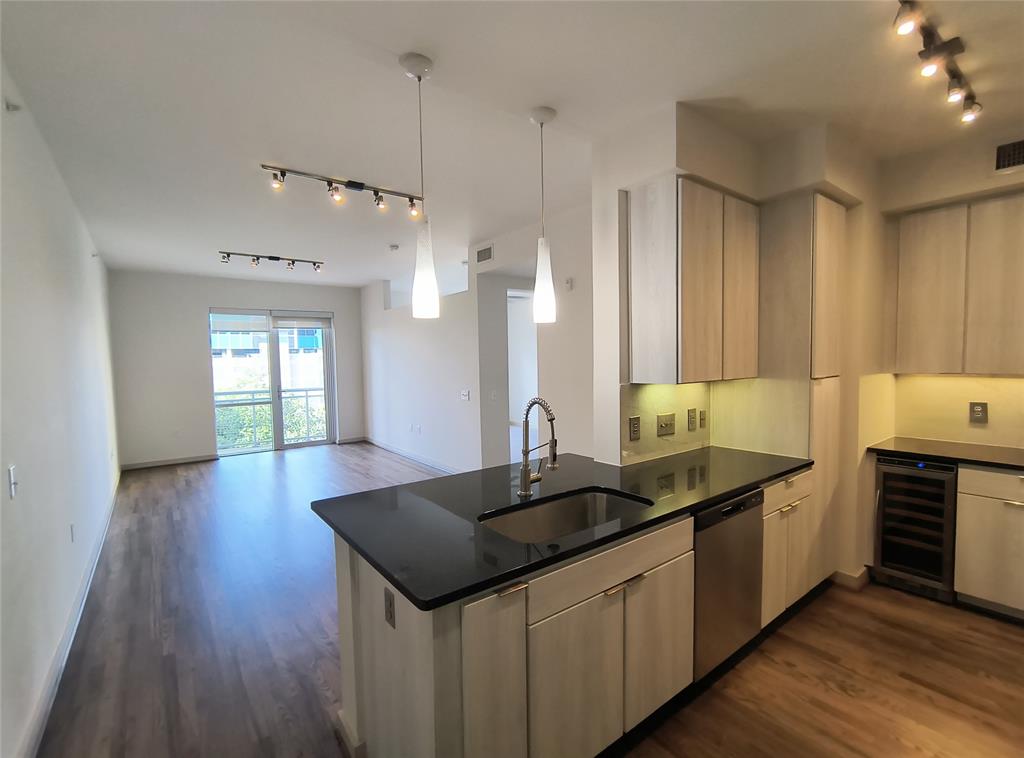 a kitchen with granite countertop a sink and cabinets