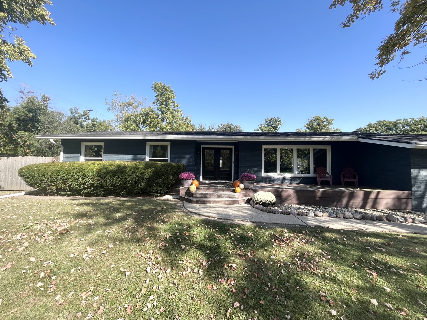 a view of a house with backyard sitting area and garden