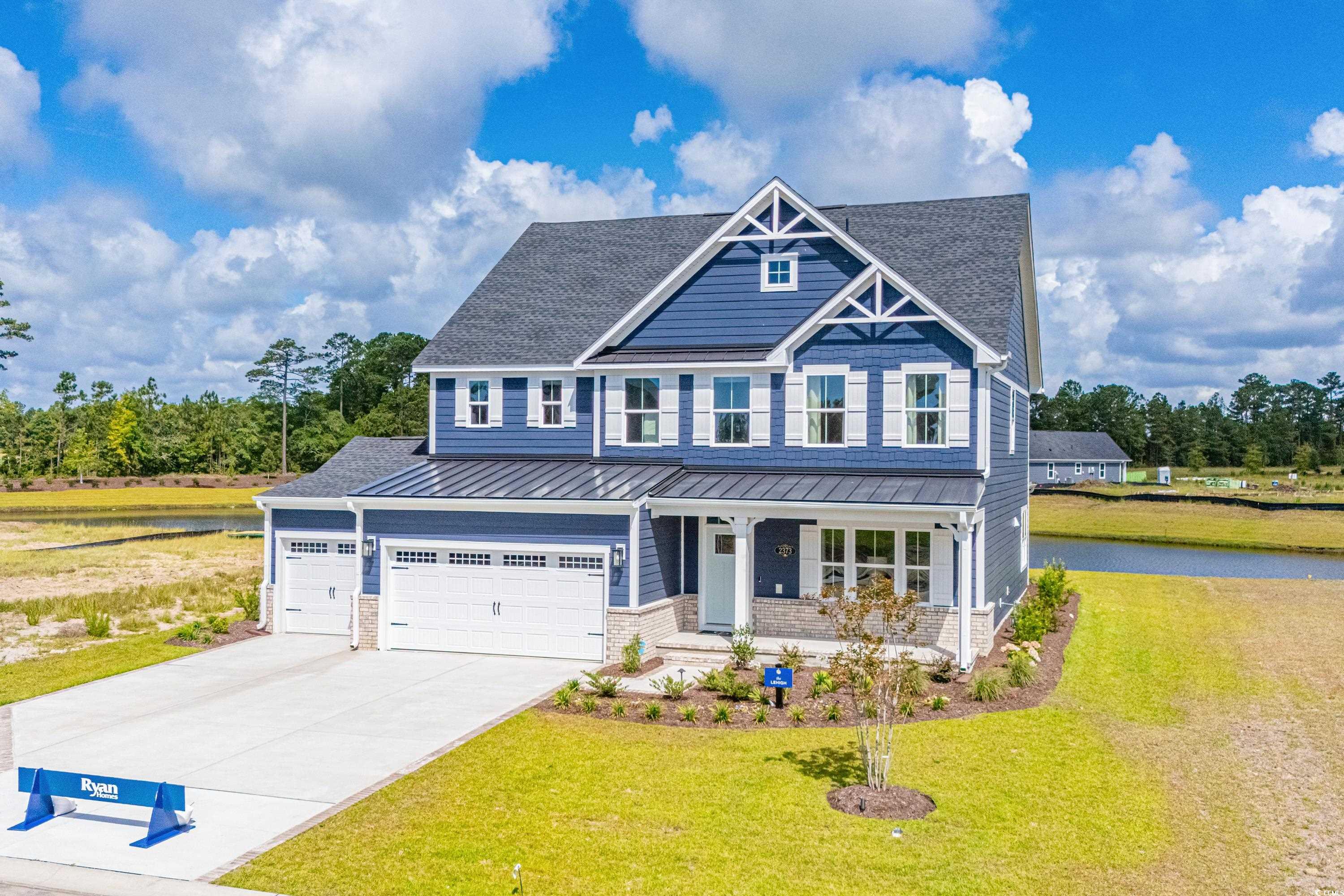 Craftsman inspired home with a front yard, a water