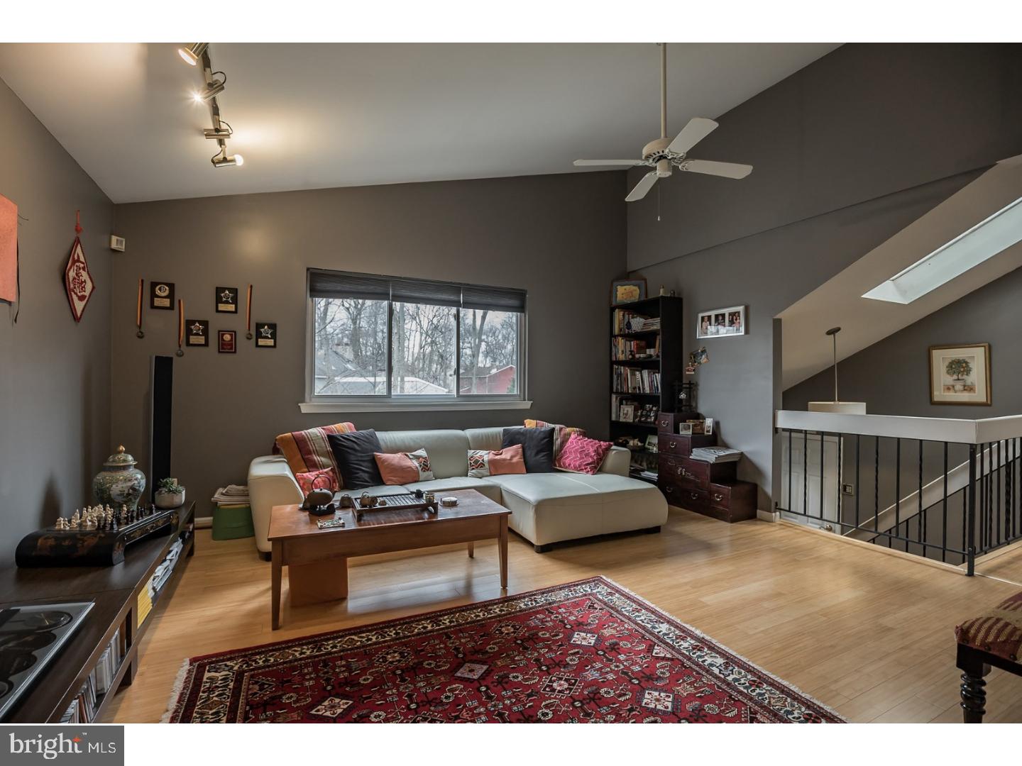 a living room with furniture a window and a flat screen tv