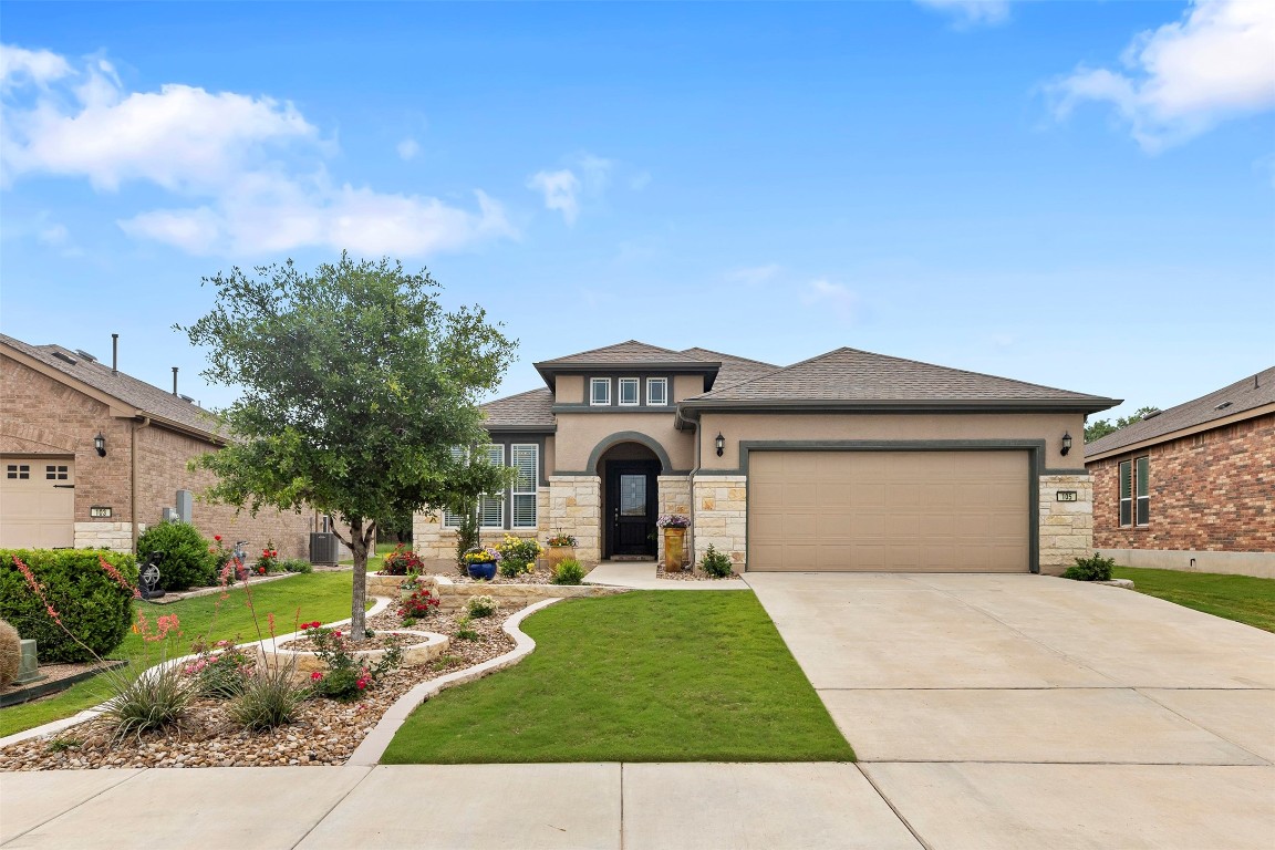 a front view of a house with a yard and garage