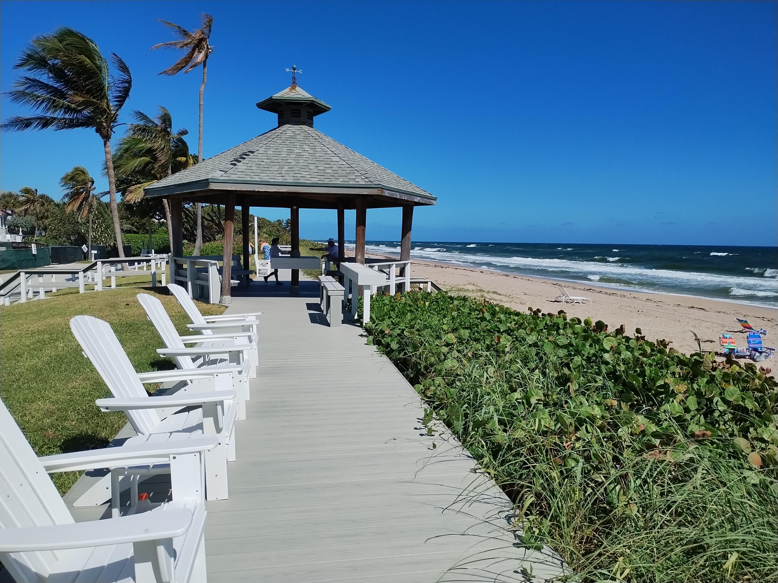 a patio with a table and chairs under an umbrella