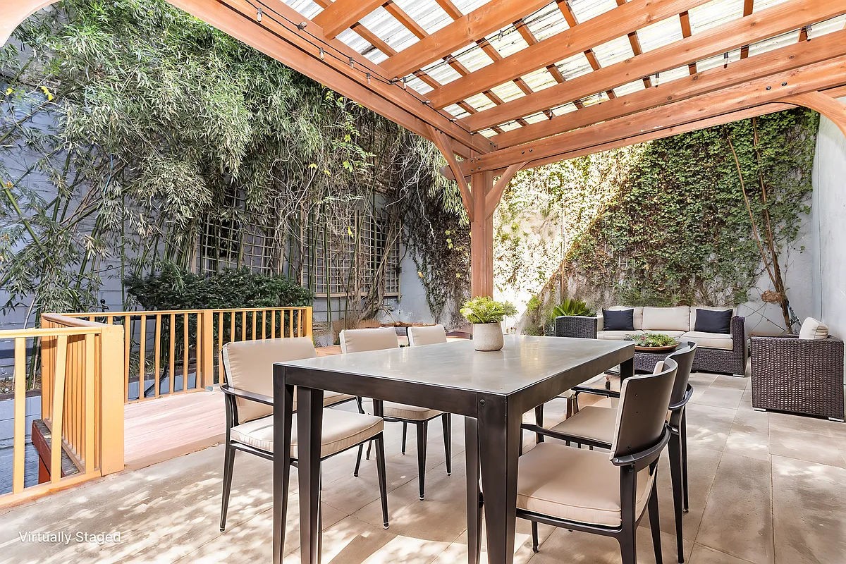 a view of a patio with a table and chairs