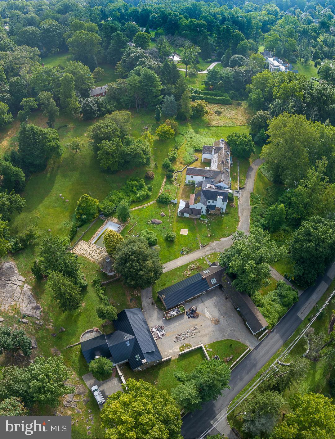 an aerial view of a house with a garden and lake view