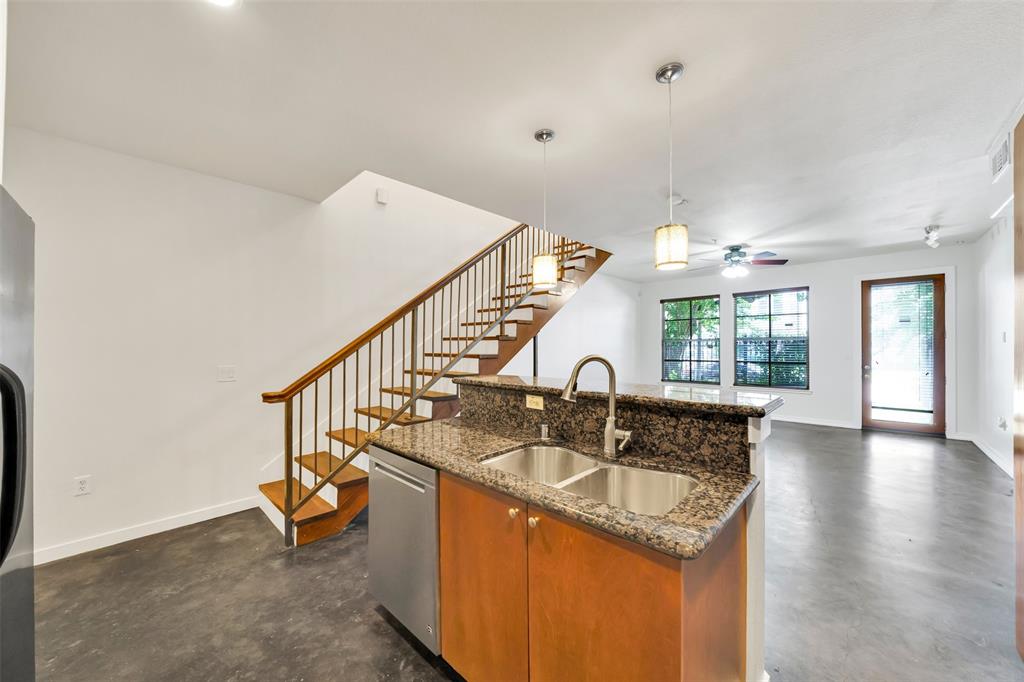 a kitchen with sink refrigerator and window