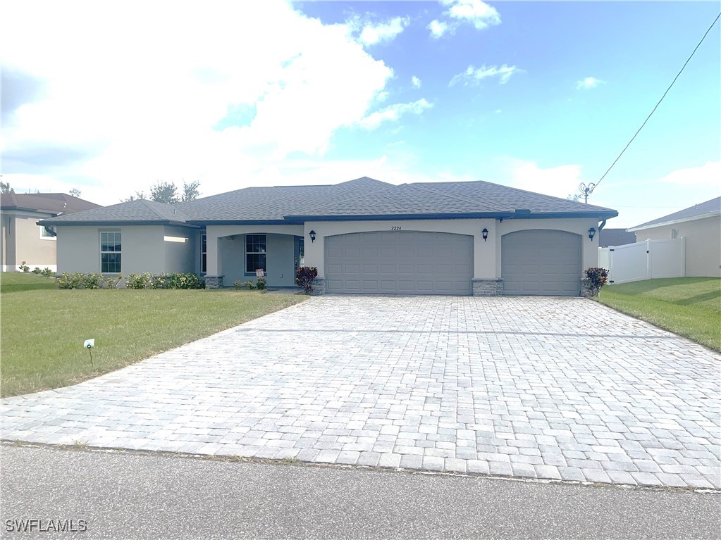 a front view of a house with a garden