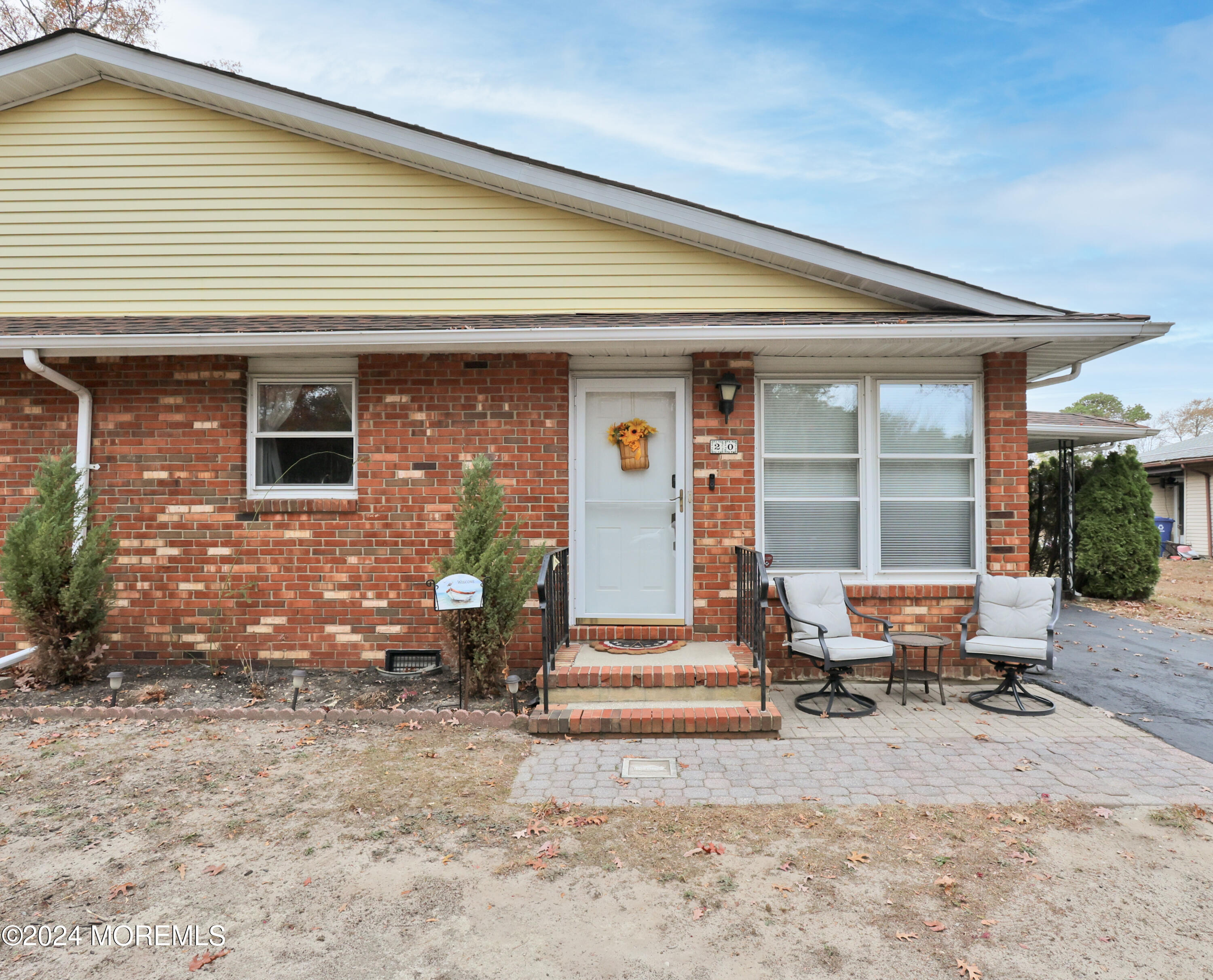 a front view of a house with outdoor seating