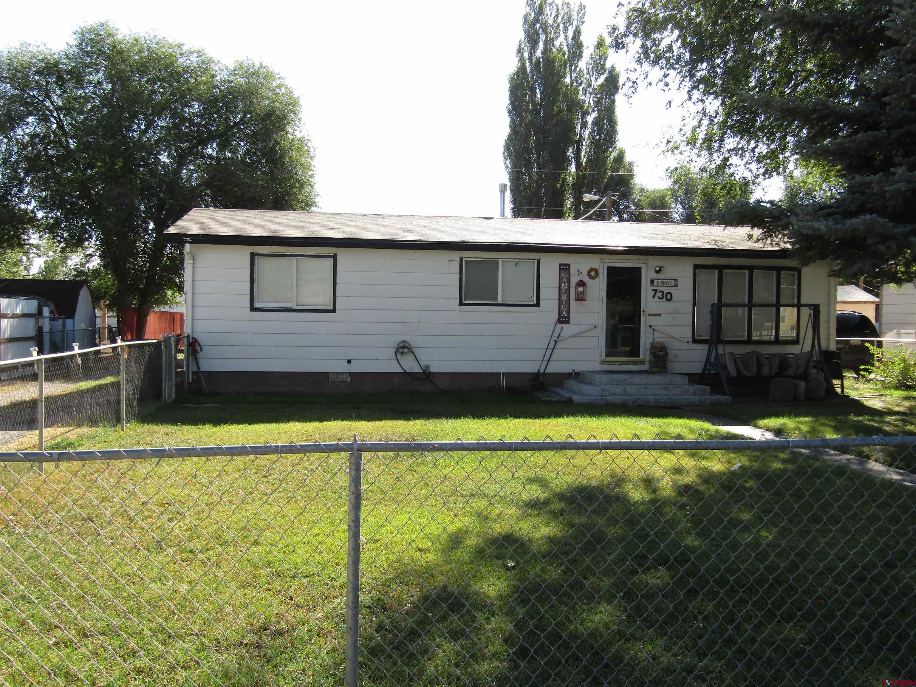 a view of a house with pool and a yard