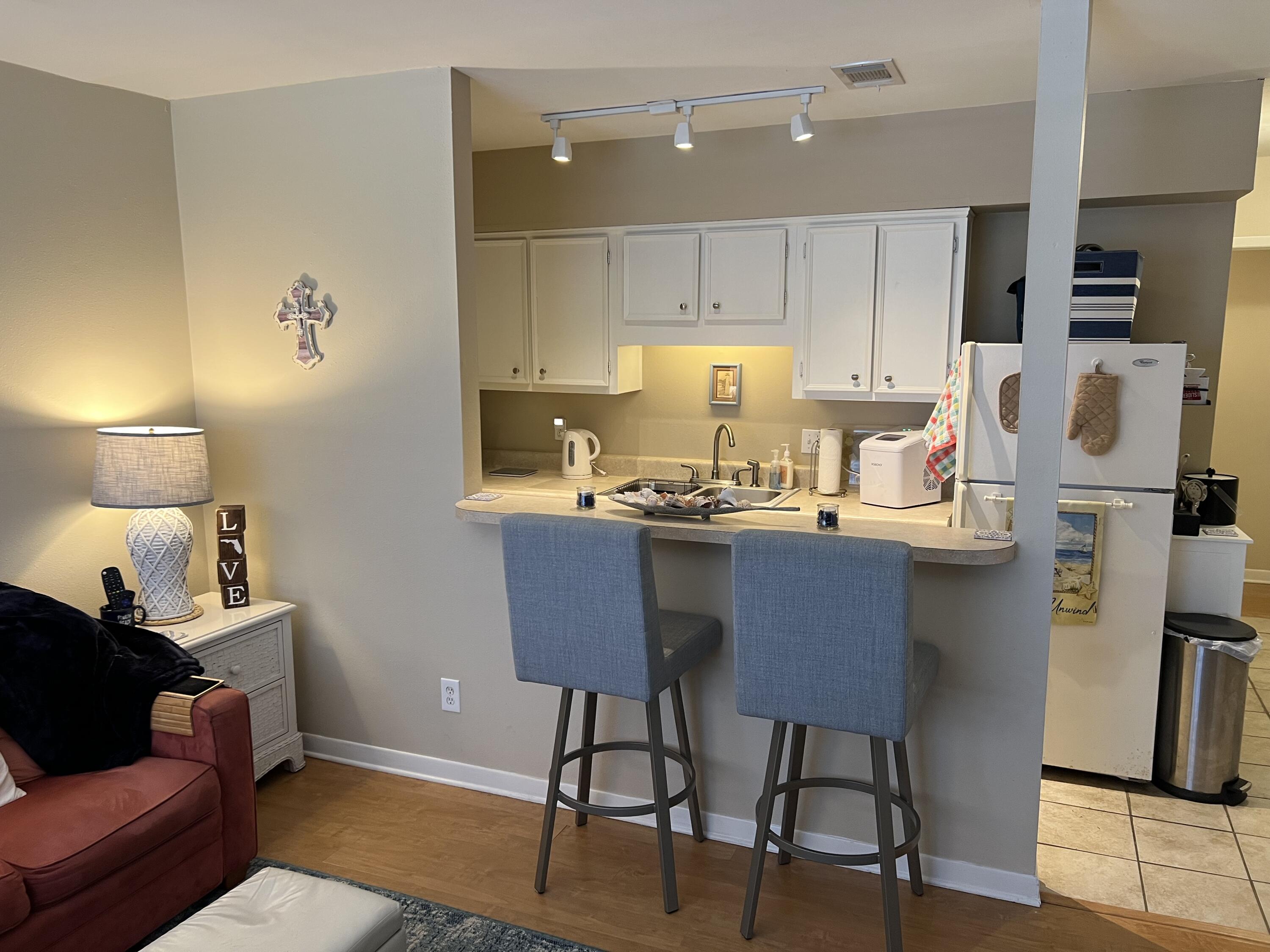 a kitchen with stainless steel appliances granite countertop a sink refrigerator and cabinets