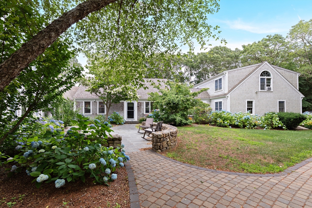 a front view of a house with a garden and plants