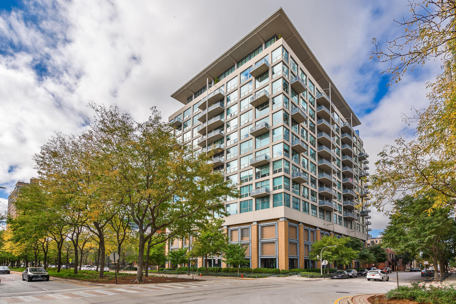 a view of a tall building next to a road