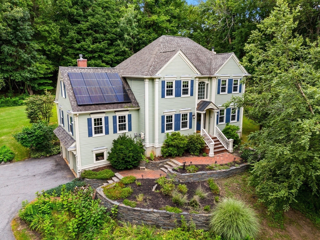 a aerial view of a house with swimming pool next to a yard