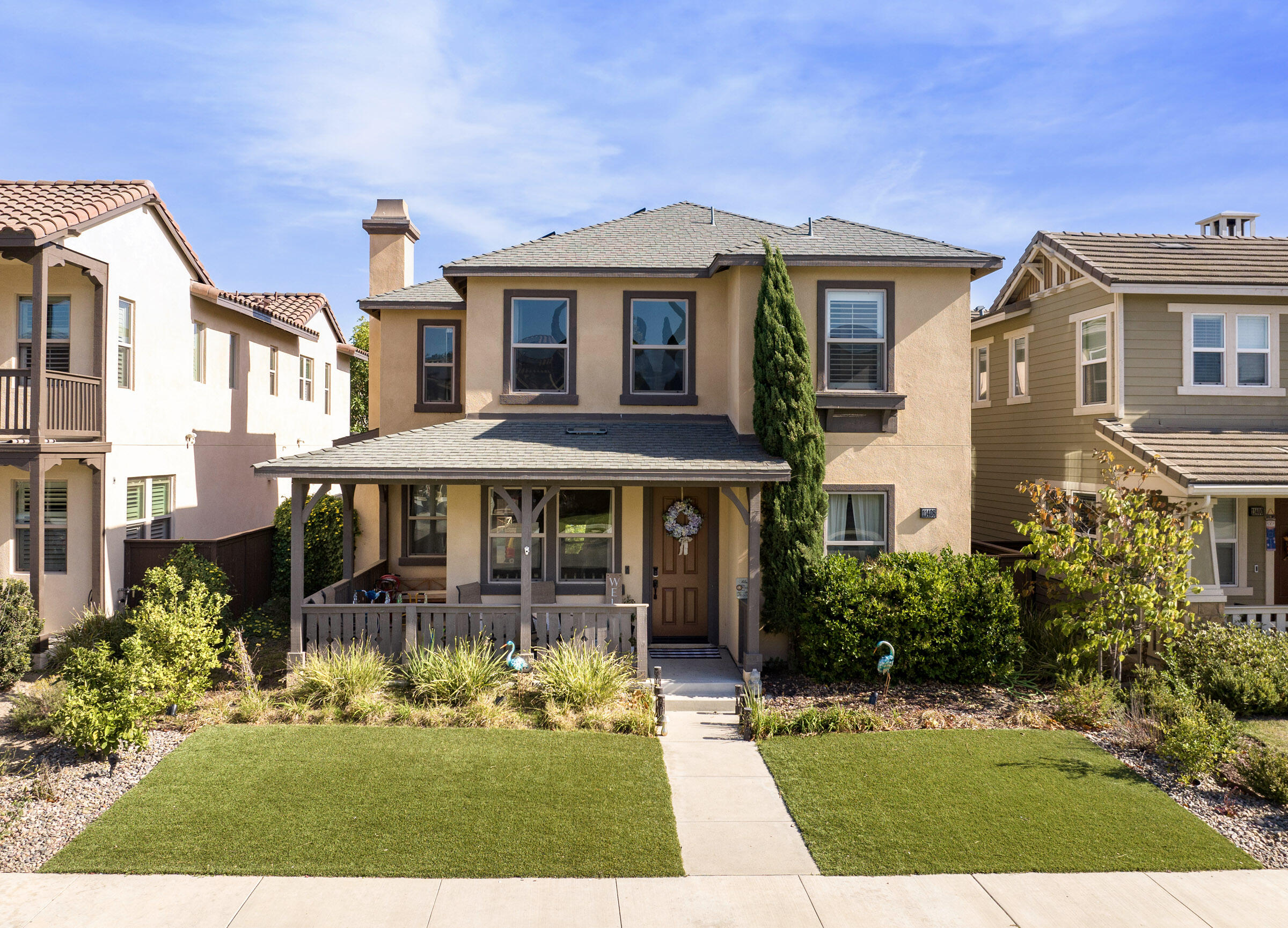 a front view of a house with a garden