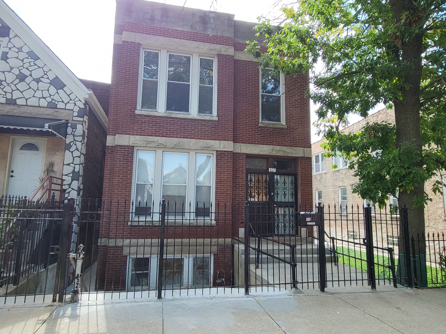 front view of a brick house with a large window