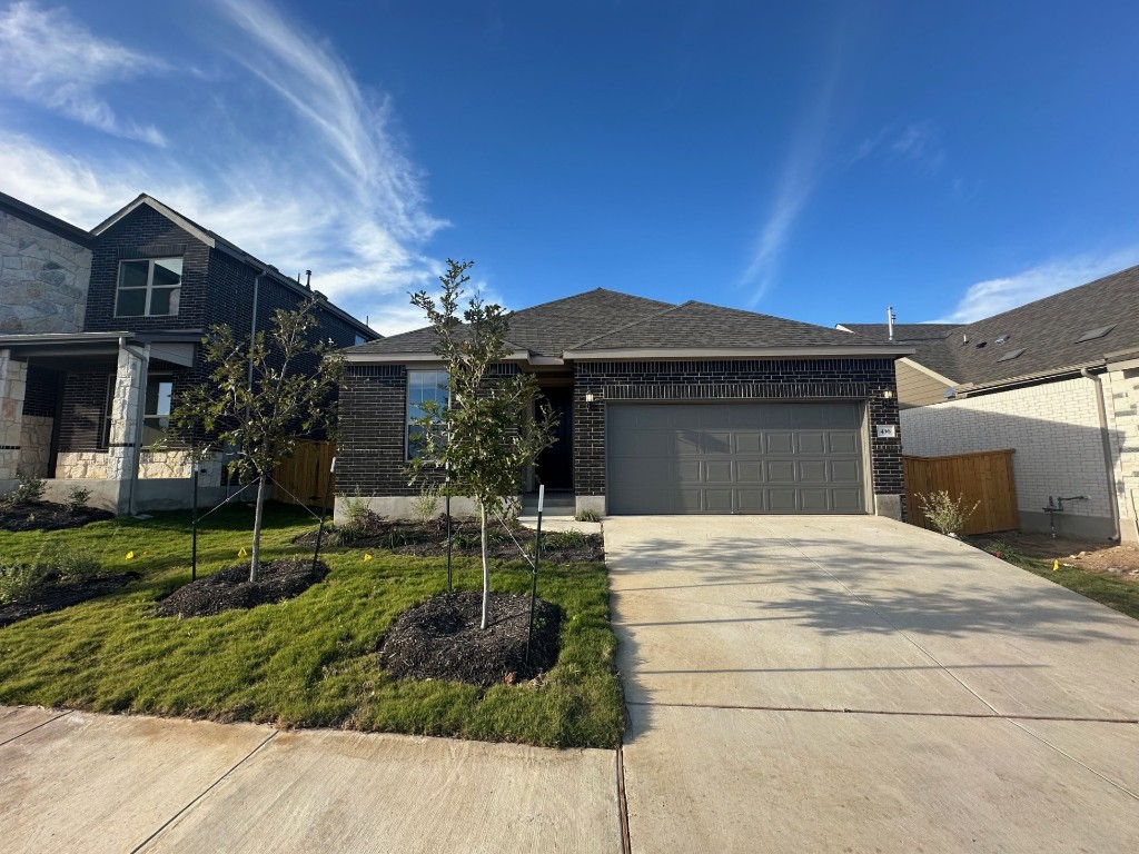 a front view of house with a garden