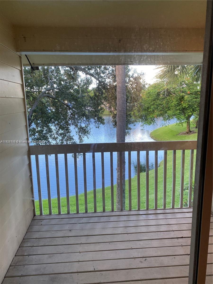 a view of a balcony with wooden floor