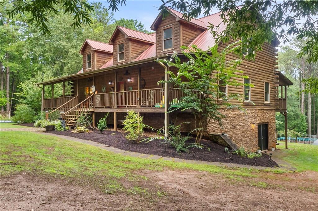 a view of a house with a yard and sitting area