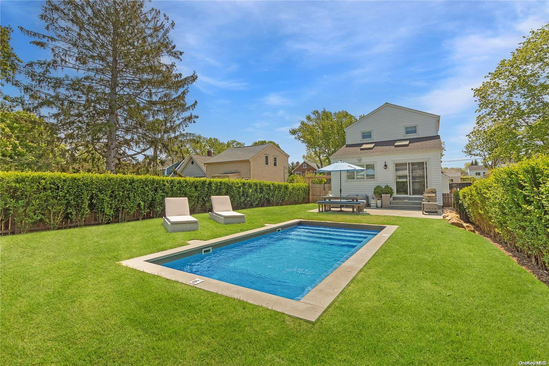 a view of an house with swimming pool yard and outdoor seating