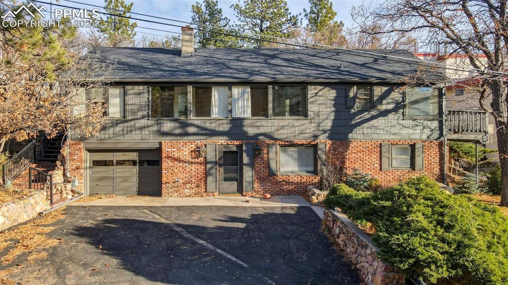 View of front facade featuring a garage