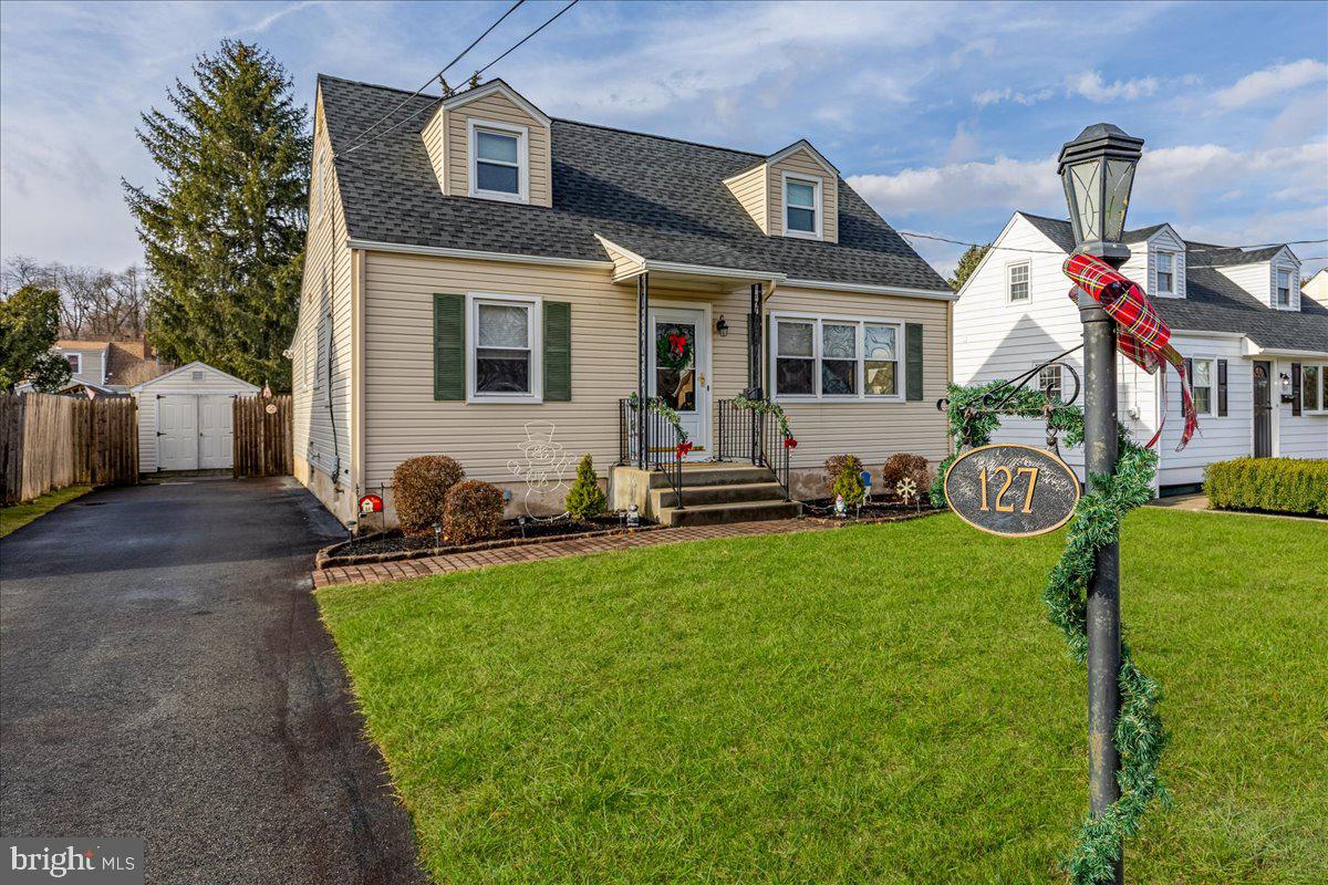 a front view of house with yard and outdoor seating