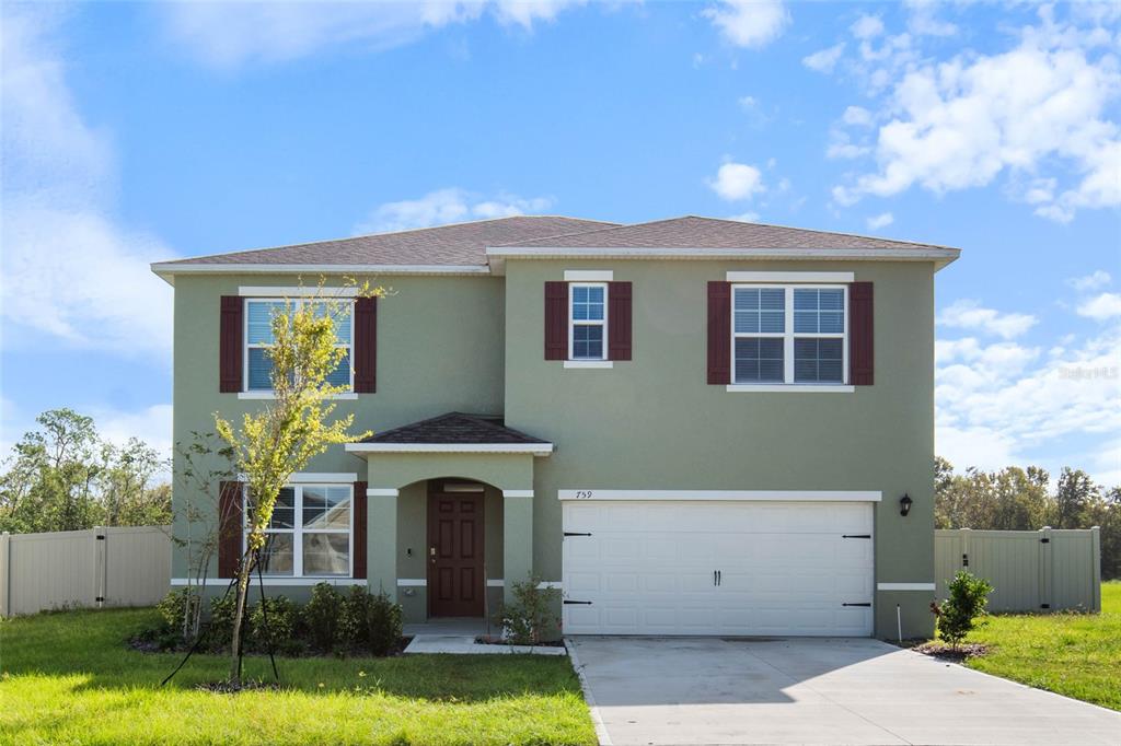 a front view of a house with a yard