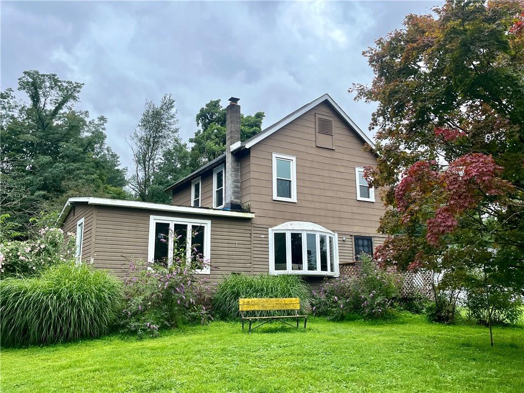 Back of house featuring a yard