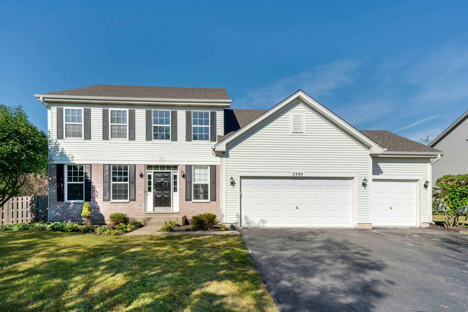 a view of a house with a yard and garage