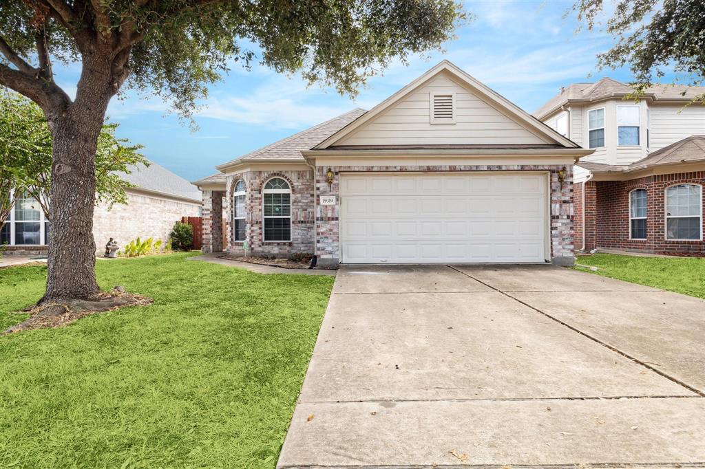 a front view of a house with a yard and garage