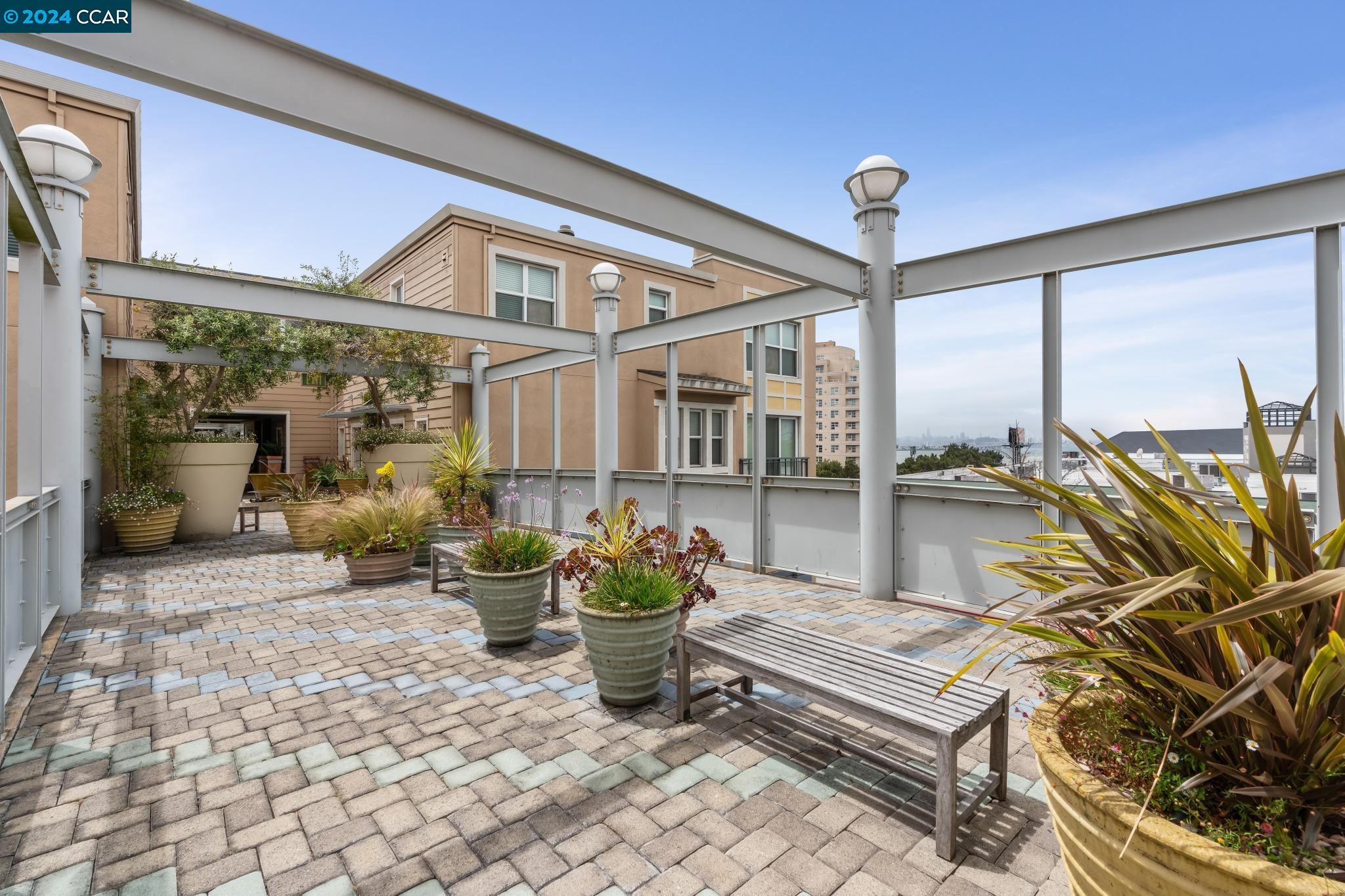 a building outdoor space with patio furniture and potted plants