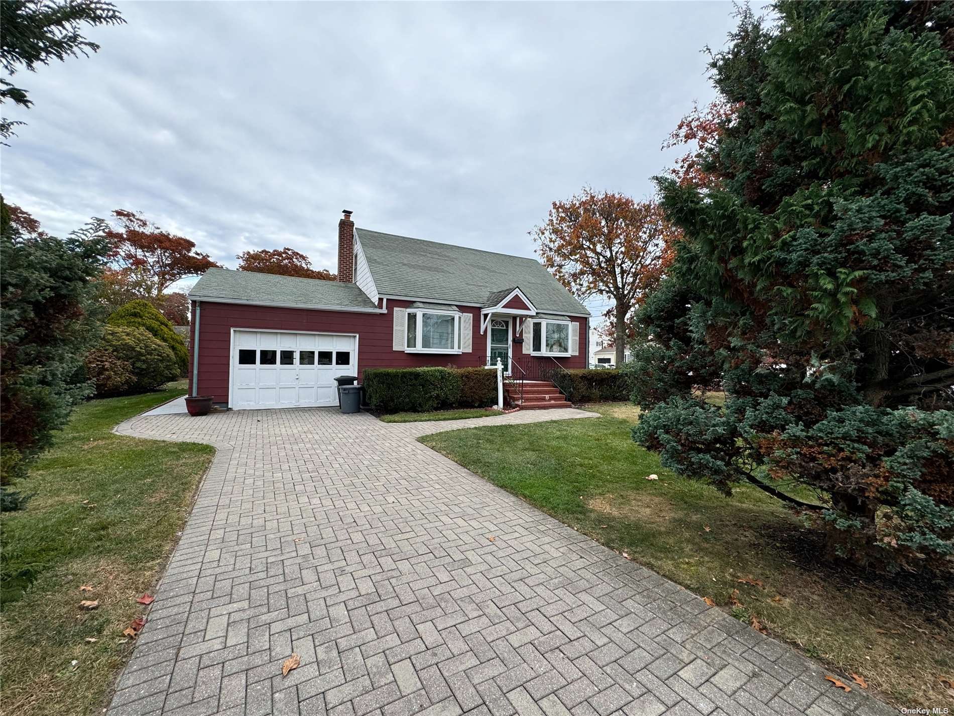 a front view of a house with a yard and a garage