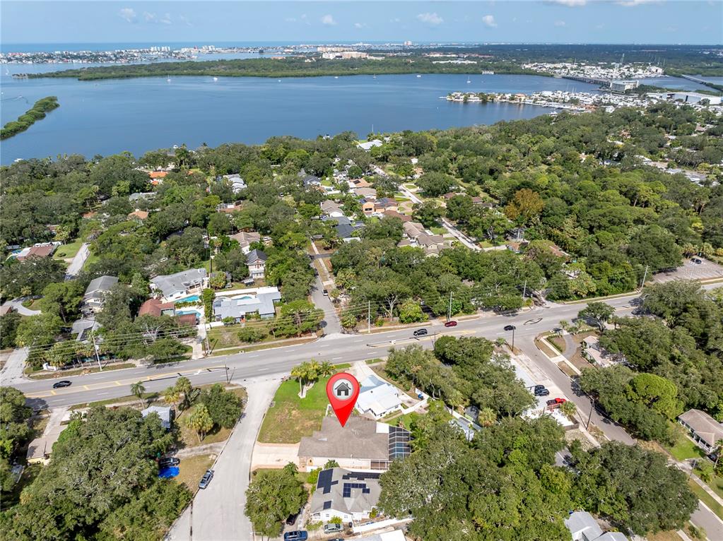 an aerial view of beach and residential houses with outdoor space