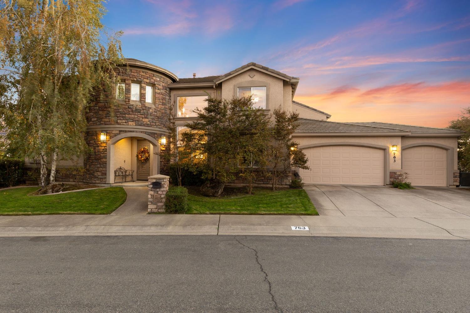 a front view of a house with a yard and garage