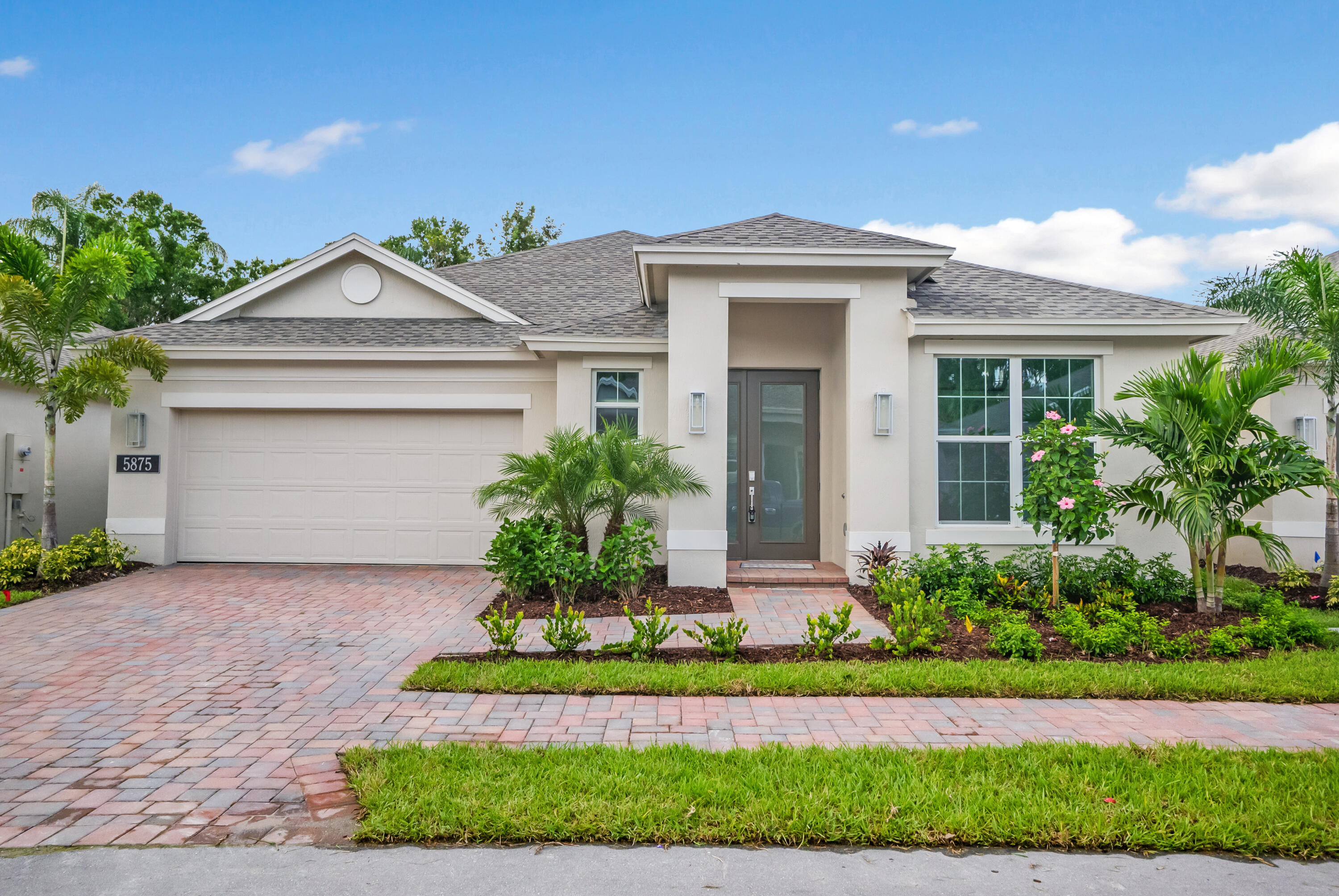 a front view of a house with a yard and garage