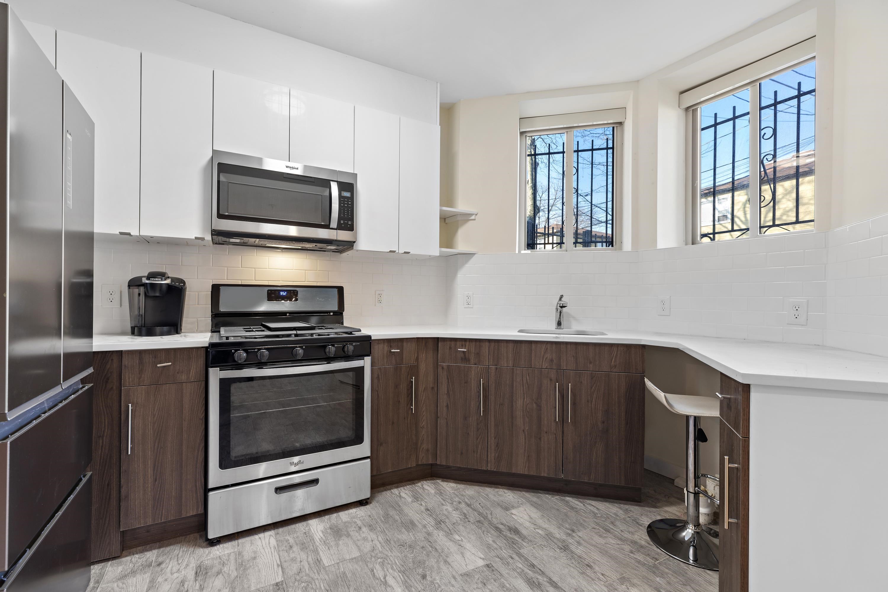 a kitchen with stainless steel appliances a stove microwave and sink