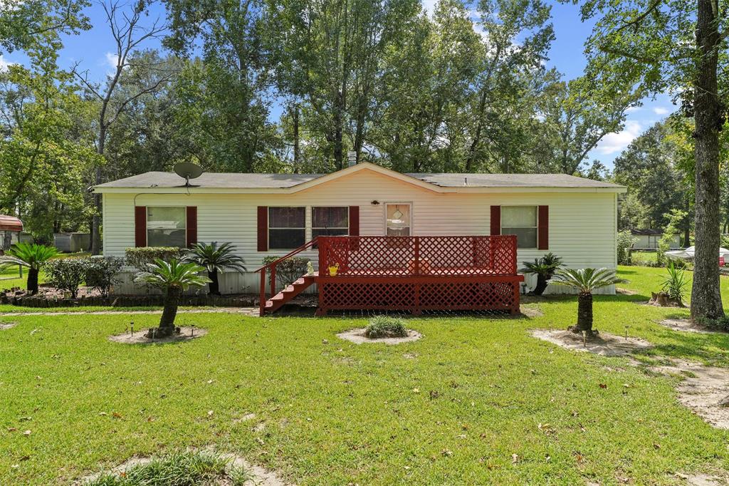 a front view of house with yard and outdoor seating