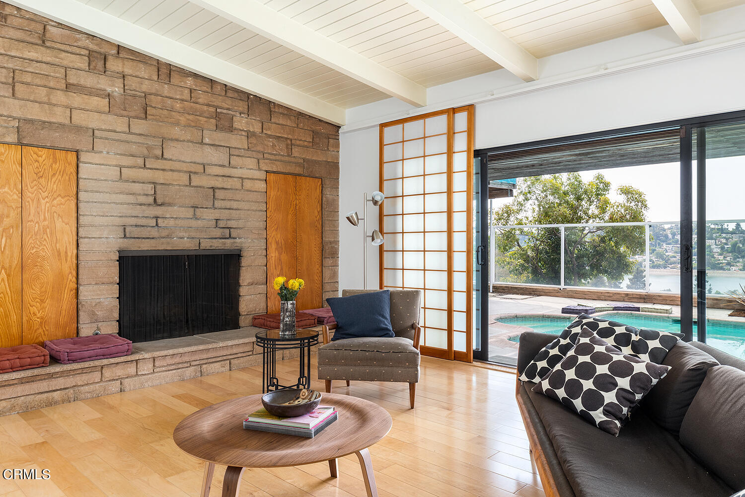 a living room with fireplace furniture and a large window