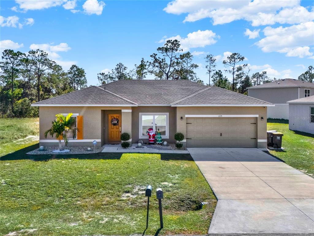 a front view of house with yard and outdoor seating