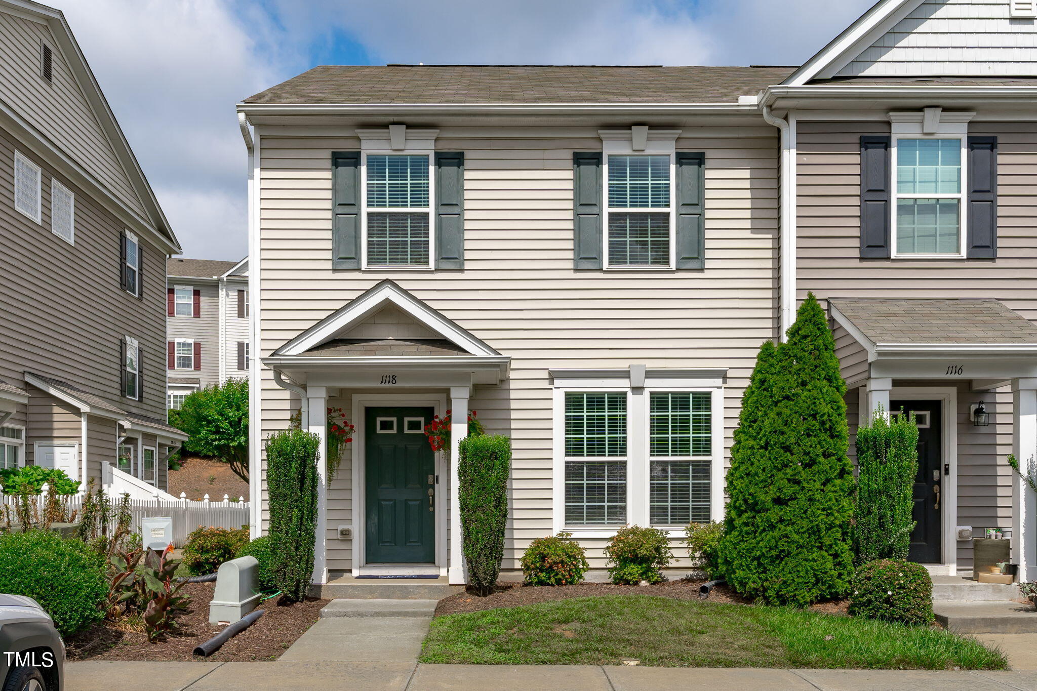 a front view of a house with garden