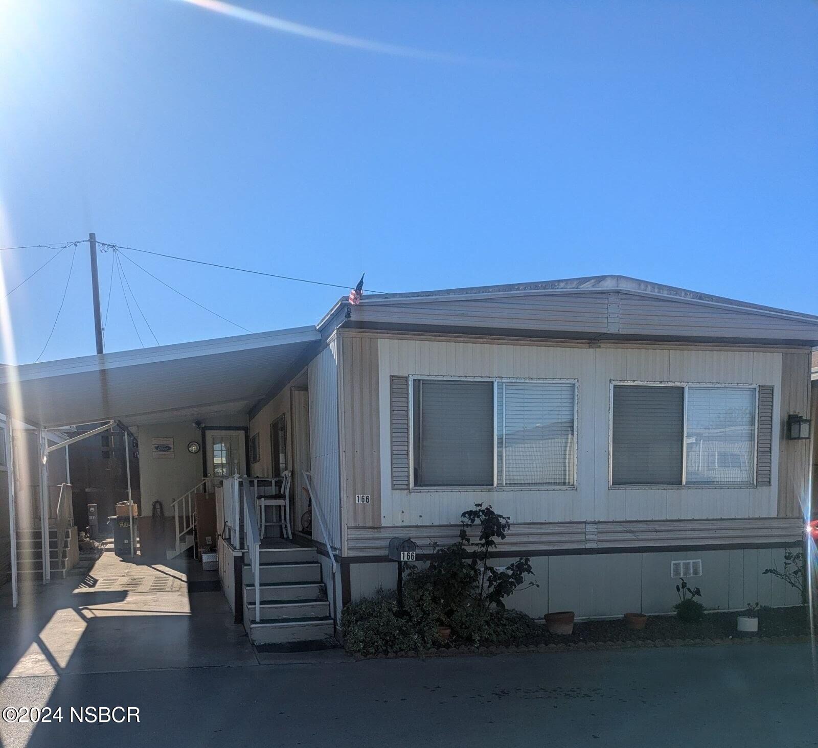 a view of a house with a small yard