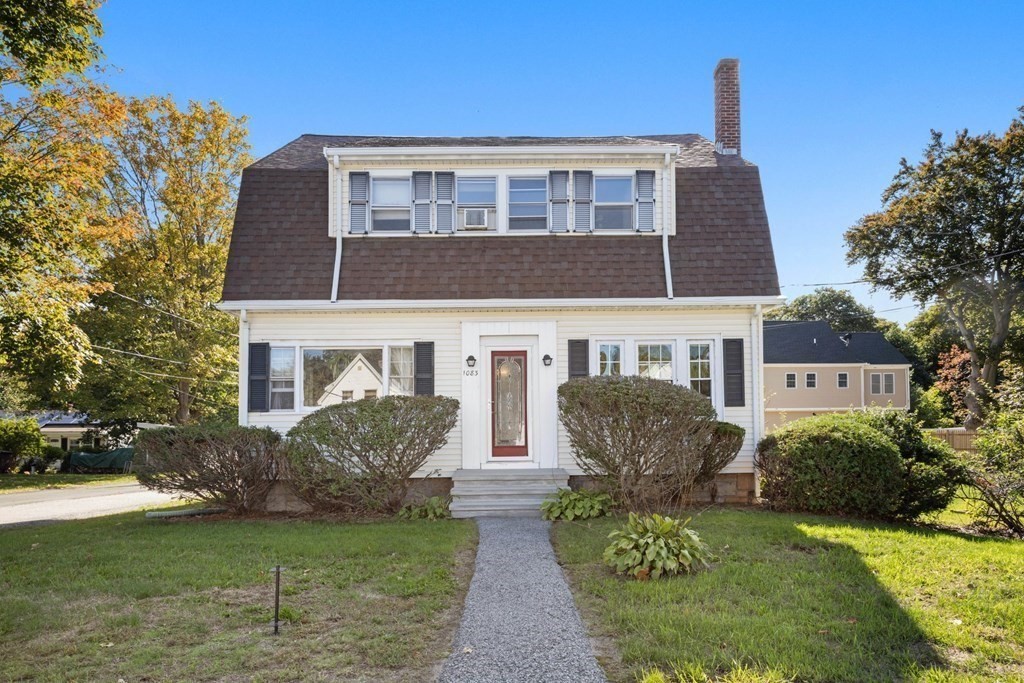 a front view of a house with garden