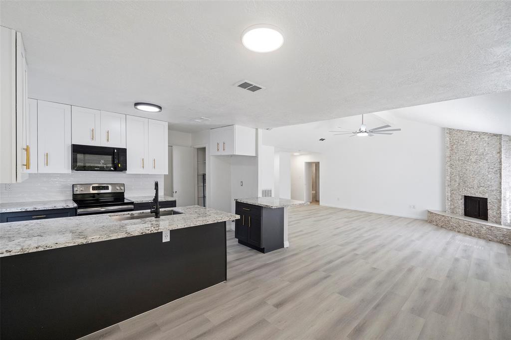 a kitchen with stainless steel appliances a refrigerator sink and microwave