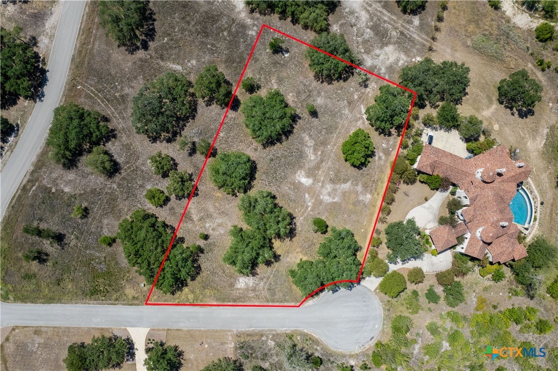 an aerial view of a house with a yard and garden