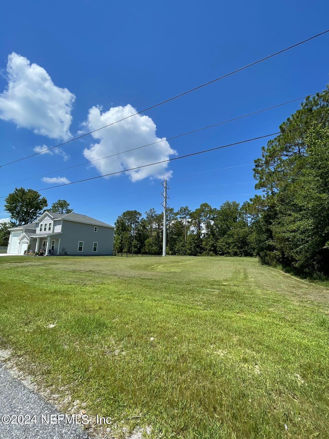 a view of a field with a building in the background