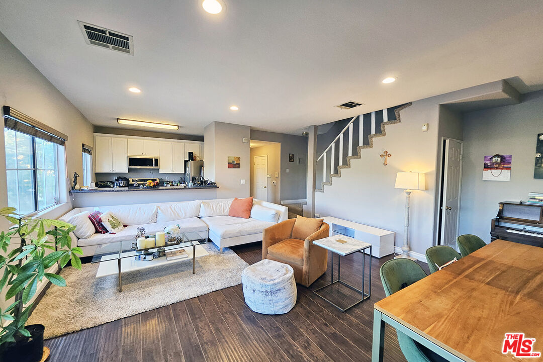 a living room with furniture and wooden floor