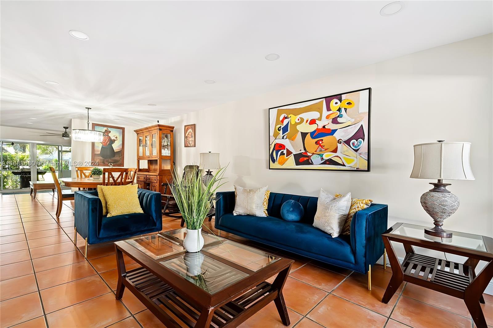 a living room with furniture a rug and a table