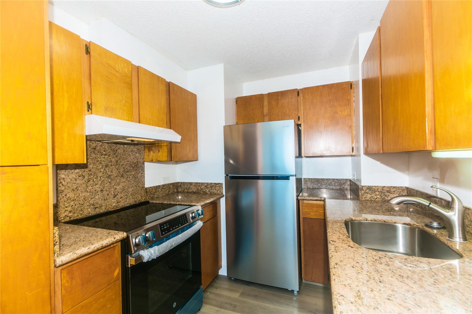 a kitchen with a refrigerator and a sink