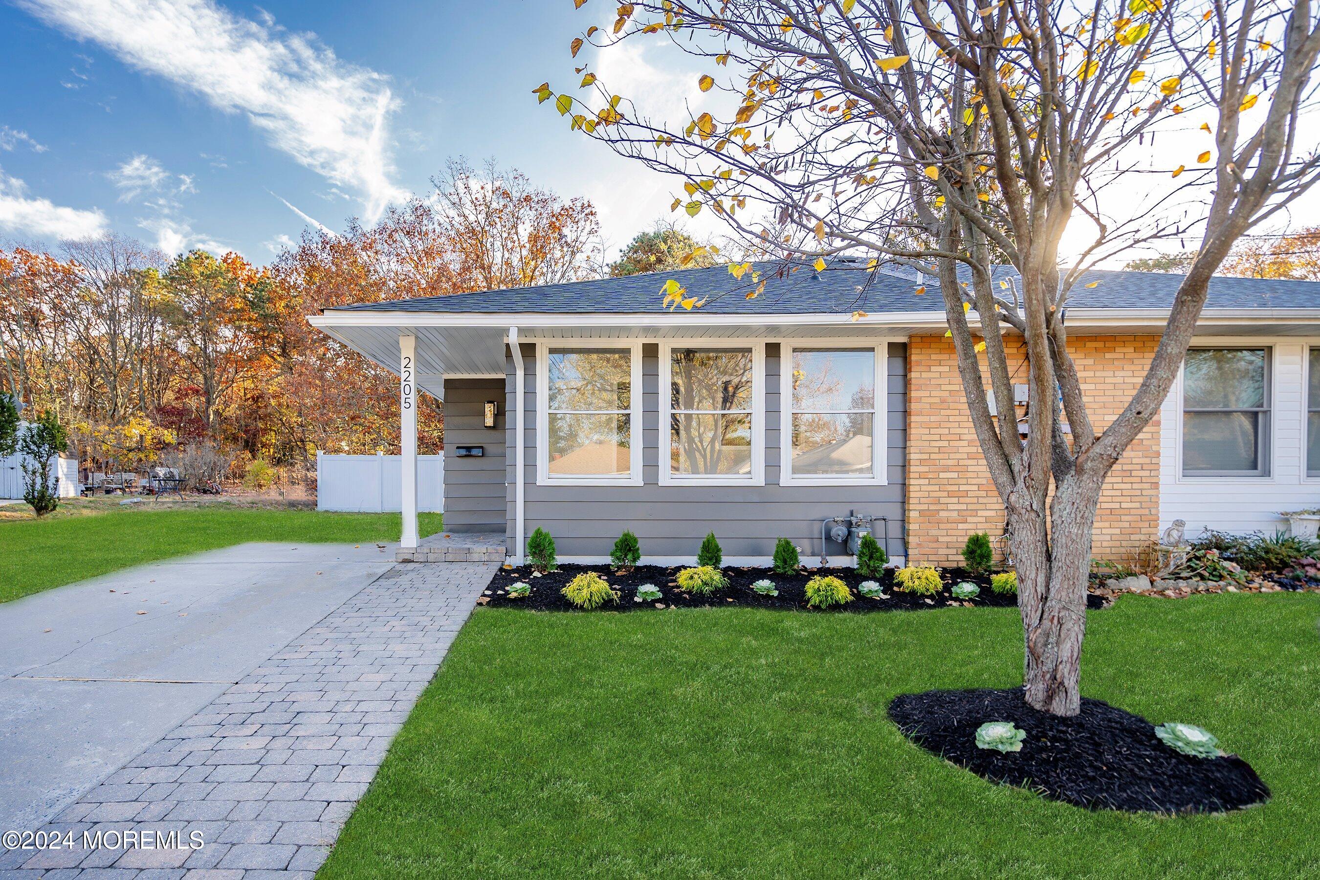 a front view of a house with a garden