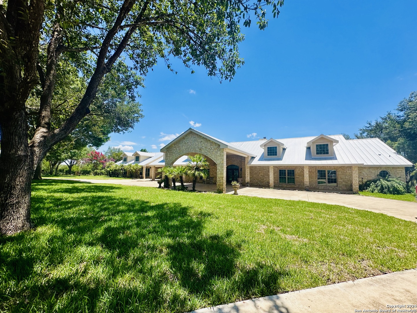 a front view of house with yard and green space