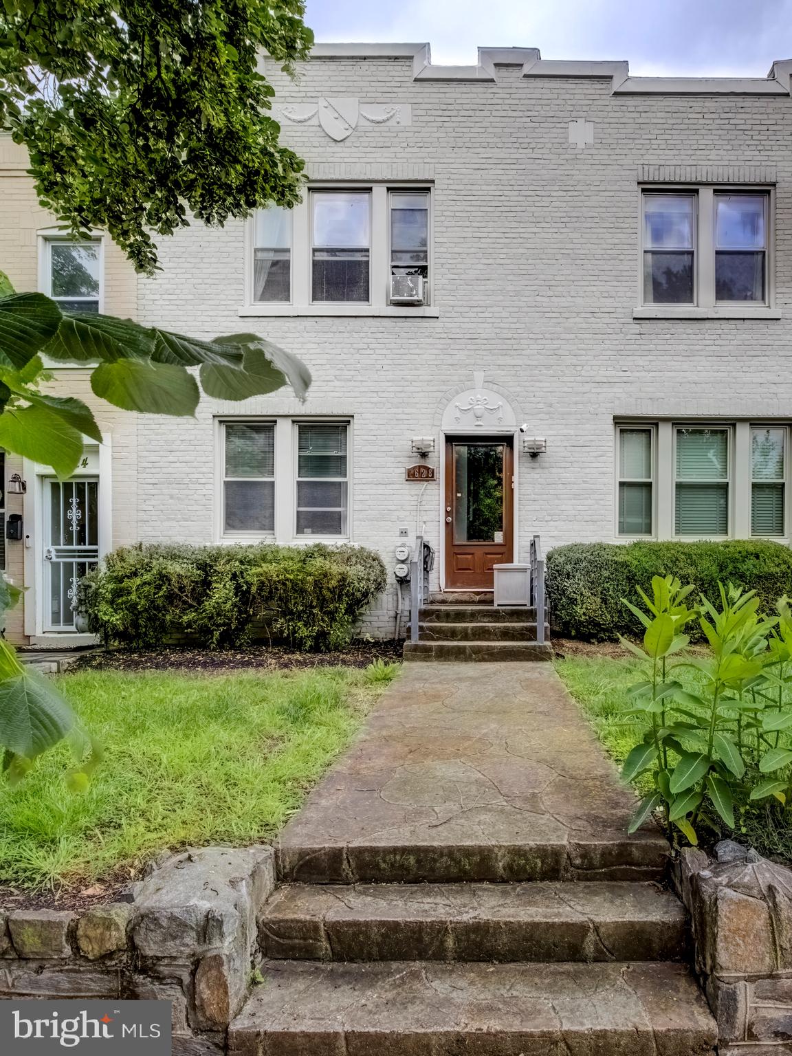 a front view of a house with garden