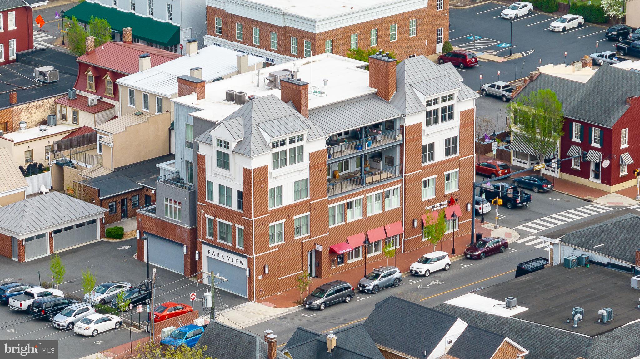 a front view of a multi story building with yard